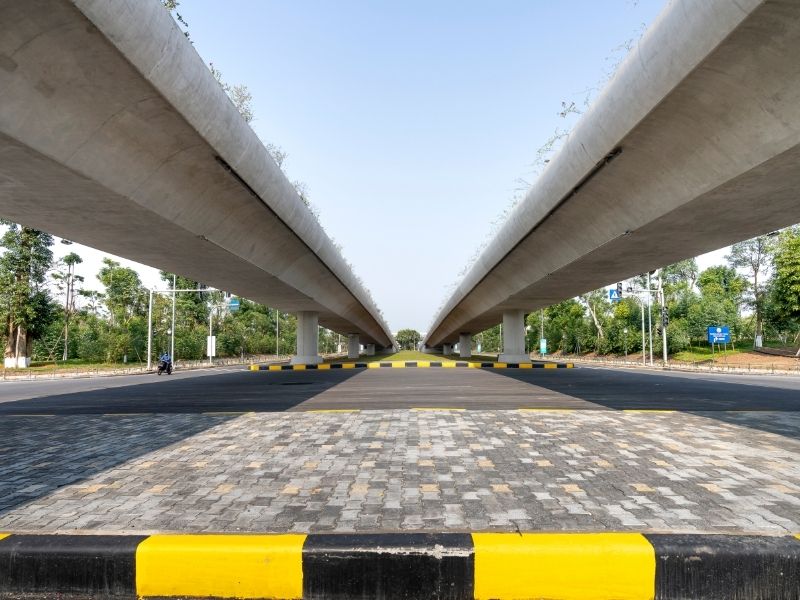 Modern roadway corridor beneath elevated transportation infrastructure designed to support long-term traffic flow and future growth